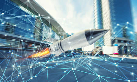Rocket fly fast with internet connection network background. concept of startup and growing companyの写真素材