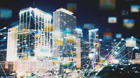 Abstract internet connection network with night city with skyscrapers at the background