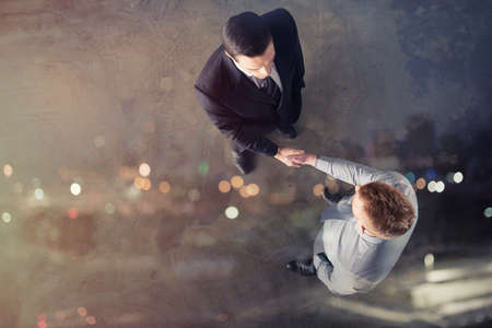 Handshaking business person in office. concept of teamwork and partnership