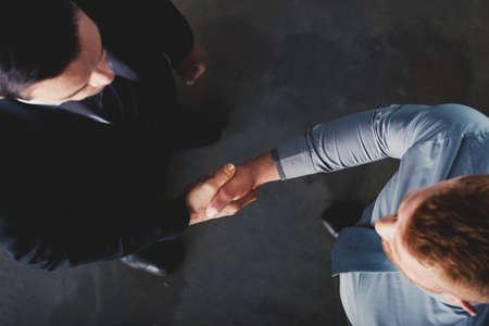 Handshaking business person in office. concept of teamwork and partnership