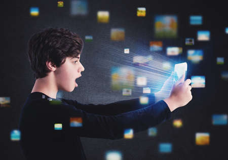 Boy surfs on internet with a tabletの写真素材