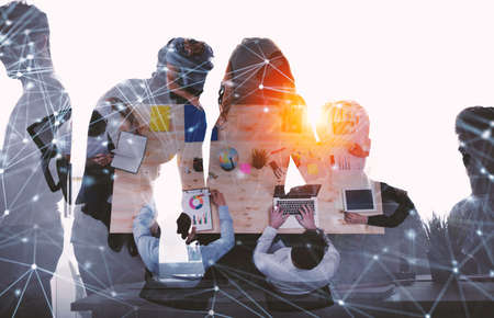 Team of businessmen work together in office. Concept of teamwork and partnership with network effect. double exposureの写真素材