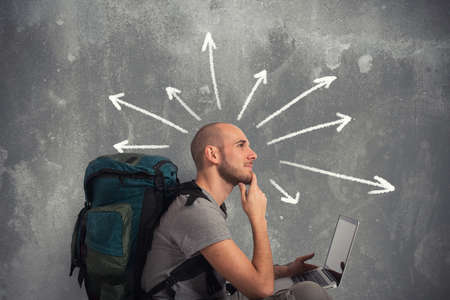 Explorer plans a new travel with his laptopの写真素材