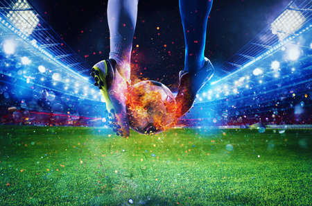Soccer players with soccerball on fire at the stadium during the matchの写真素材