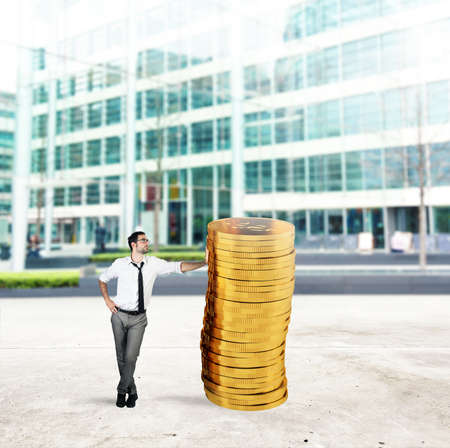 Successful businessman with a pile of moneyの写真素材