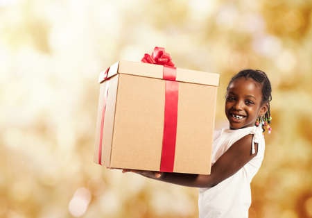 Happy little girl with a Christmas giftの写真素材