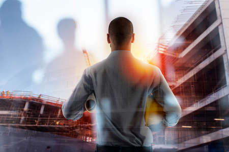 Businessman Architect analyzes the works of a building. double exposureの写真素材
