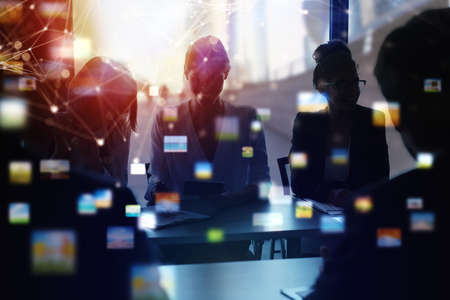 Business people work together in office. Concept of teamwork and partnership. double exposure with network effectsの写真素材