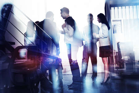 Business people work together in office. Concept of teamwork and partnership. double exposure with...