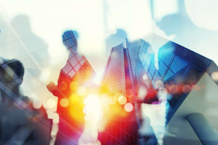 Silhouette of business people work together in office. Concept of teamwork and partnership. double...