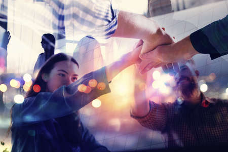 Handshaking business person in office. concept of teamwork and partnership. double exposure with light effectsの写真素材