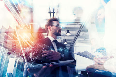 Business people work together in office with a laptop. Concept of teamwork and partnership. double exposureの写真素材