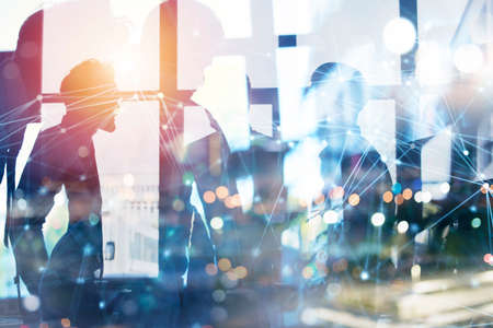 Business people work together in office with internet network effects. Concept of teamwork and partnership. double exposureの写真素材