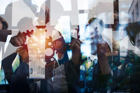 Business team connect pieces of gears. Teamwork, partnership and integration concept. double...