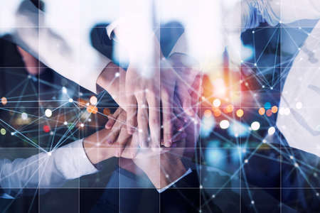 Business people putting their hands together. Concept of startup, integration, teamwork and partnership. Double exposureの写真素材