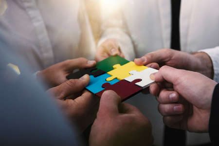 Teamwork of partners. Concept of integration and startup with puzzle piecesの写真素材