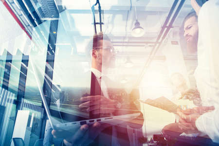 Business people work together in office with a laptop. Concept of teamwork and partnership. double...
