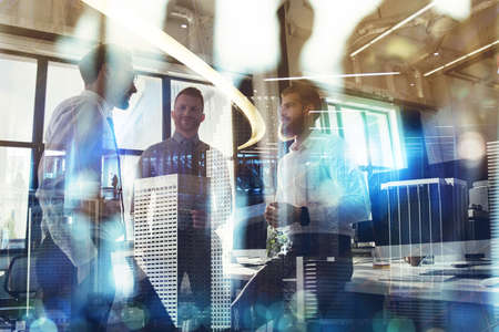 Business people work together in office. Concept of teamwork and partnership. double exposure with...