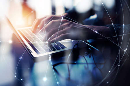 Business man works in office with laptop. Concept of internet network. double exposureの写真素材