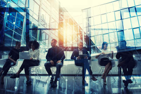 Business people connected on internet network with laptop and tablet. concept of startup company. double exposureの写真素材