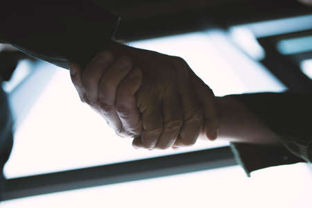 Handshaking business person in the office with network effect. concept of teamwork and partnership