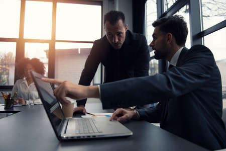 Business people work together in office with a laptop. Concept of teamwork and partnershipの写真素材