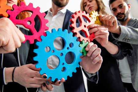 Business team connect pieces of gears. Teamwork, partnership and integration conceptの写真素材