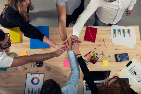 Business people putting their hands together. Concept of integration, teamwork and partnershipの写真素材
