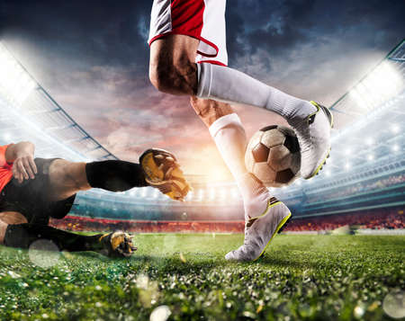Soccer players with soccerball at the stadium during the matchの写真素材