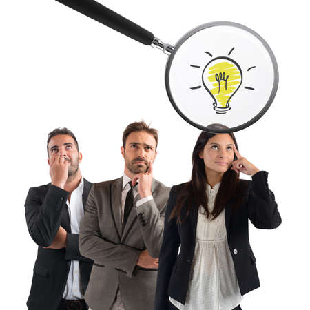 Magnifying glass examines the idea of a young businesswoman