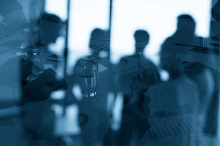 Silhouette of young workers in the office with statistic worksheets. concept of teamwork and business. double exposureの写真素材