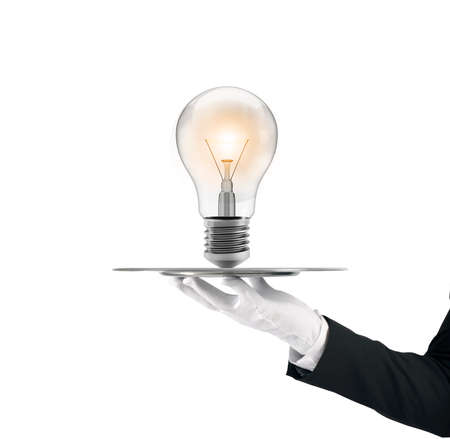 Waiter that holds a tray with a lightbulb. Concept big ideaの写真素材