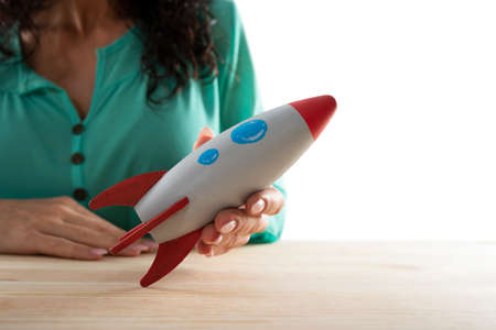 Businesswoman launches his company with a rocket. Concept of startup and innovation