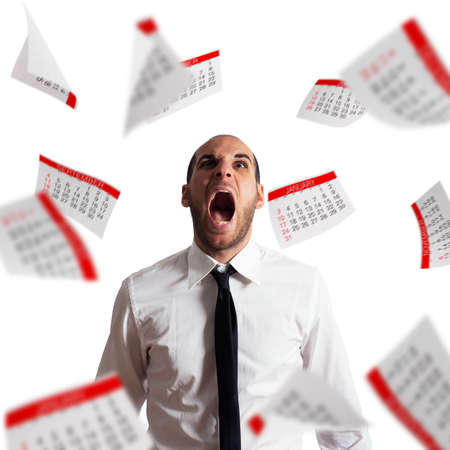 Businessman stressed and overworked screaming in office with flying paper sheetsの写真素材