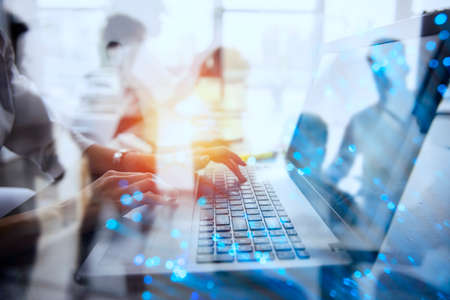Businesswoman works in office with a laptop with internet effects.