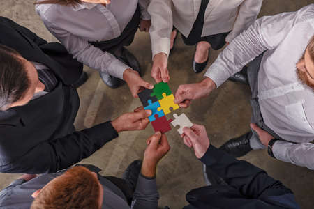 Teamwork of partners. Concept of integration and startup with puzzle pieces.の写真素材