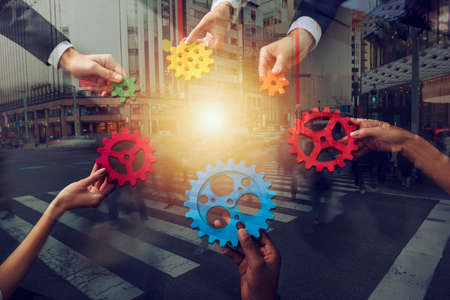 Business team connect pieces of gears. Teamwork, partnership and integration concept. Double exposureの写真素材