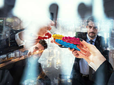 Business team connect pieces of gears. Teamwork, partnership and integration concept. double exposureの写真素材