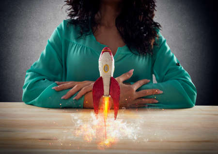 Businesswoman launches his company with a rocket. Concept of startup and innovation.