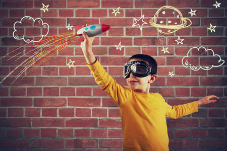 Child plays with a rocket. Concept of imagination