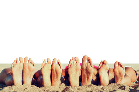 Group of friends having fun on the beach with their foots. Concept of summertime. Isolated on white backgroundの写真素材