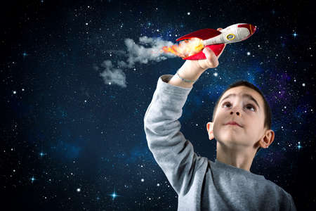 Child plays with a rocket. Concept of imaginationの写真素材