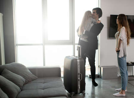 Father comes back to home from a travelの写真素材