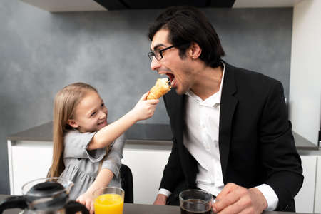 Happy family have a breakfast at homeの写真素材