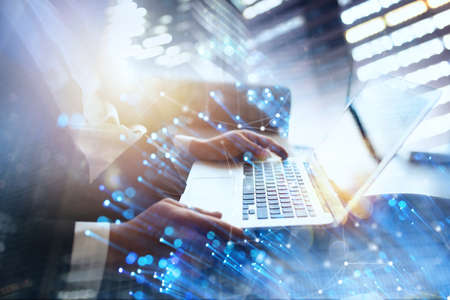 Businessman works in office with a laptop with internet effects. Concept of internet sharing and...