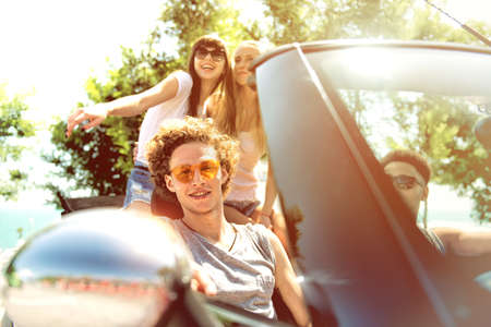 Young friends ready to travel by the car