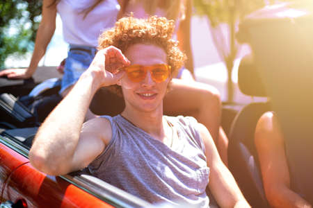 Young friends ready to travel by the carの写真素材