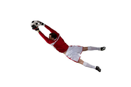 Goalkeeper catches the ball in the stadium. Isolated on white backgroundの写真素材