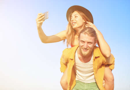Happy group of friend makes a selfie with a mobile phone.