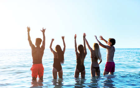 Group of friends having fun on the beach. Concept of summertimeの写真素材